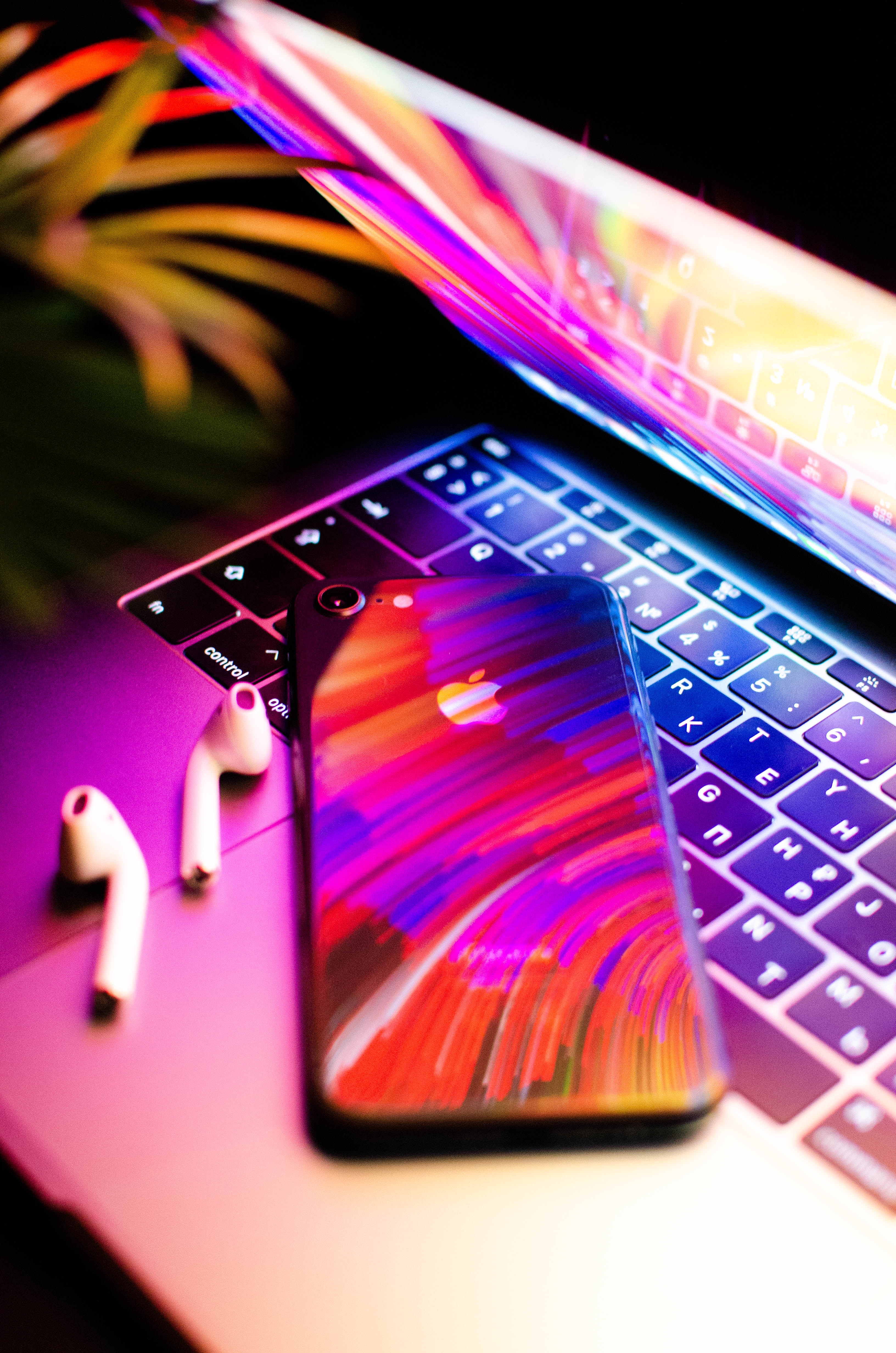 an iphone on a macbook with dramatic lighting